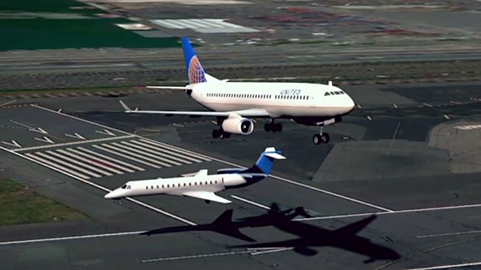 two jet planes flying at an angle to each other